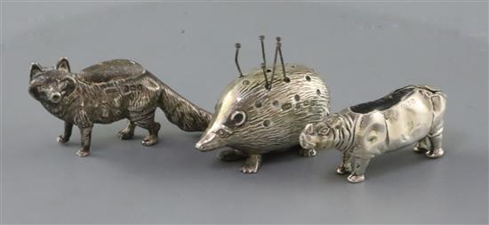 An Edwardian novelty silver pin cushion, modelled as a rhinoceros, Levi & Salaman, Birmingham, 1908, 46mm & two others.